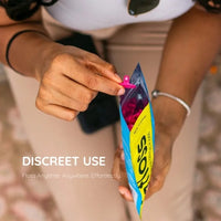 Taking a pink Gfloss flosser from its resealable pouch — discreet flossing anywhere