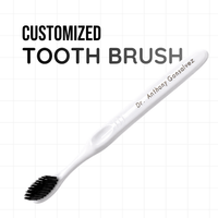 Customized toothbrush — white handle engraved with a doctor's name