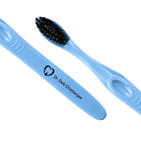 Blue engraved toothbrushes with soft black bristles and clinic logo