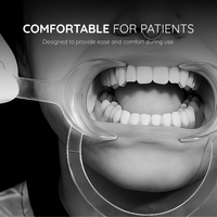 Cheek retractor in use, holding the cheeks and lips clear during a dental procedure